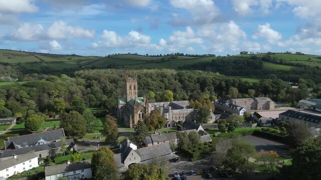 Buckfast, Devon, England: DRONE VIEWS: The village of Buckfast & Buckfast Abbey; in the background is Dartmoor National Park. The Abbey is run by Benedictine monks and produces its own wine.