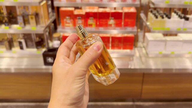 Perfume and Eau de Toilette Bottles on Display in Cosmetics Store &ndash; Fragrance Products on Shelf with Blurred Perfume Background