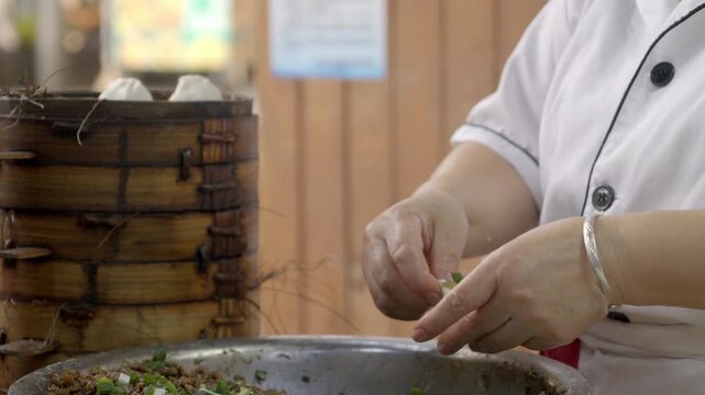 The chef is making meat buns