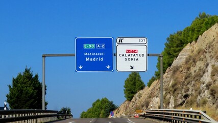 Overhead information signs on the A-2 motorway in Spain ,The blue sign indicates the direction straight ahead toward Medinaceli and Madrid.exit 237, October 13, 2026 © GenadiyGM