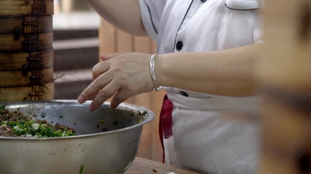 The chef is making meat buns