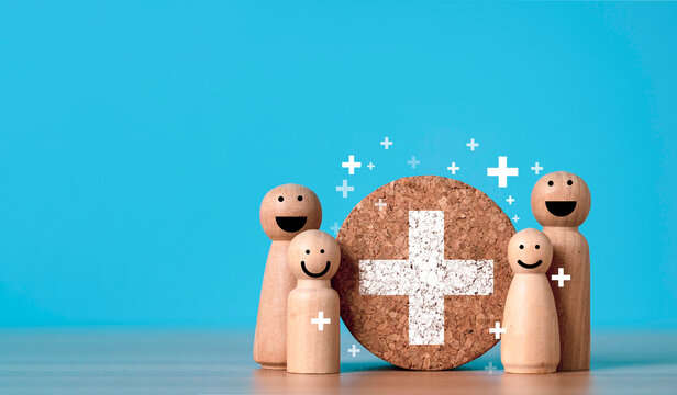 Family health insurance and healthcare protection concept with smiling family figures around a white medical cross symbolizing medical safety coverage and wellness health benefits.
