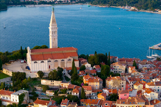 Aerial view of Rovinj, Croatia, showing the historic old town on a rocky peninsula surrounded by the Adriatic Sea at dusk