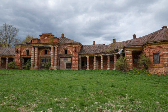 Ancient stables of the stud farm of Count Stroganov on a cloudy May day. Volyshevo Estate. Pskov Region, Russia