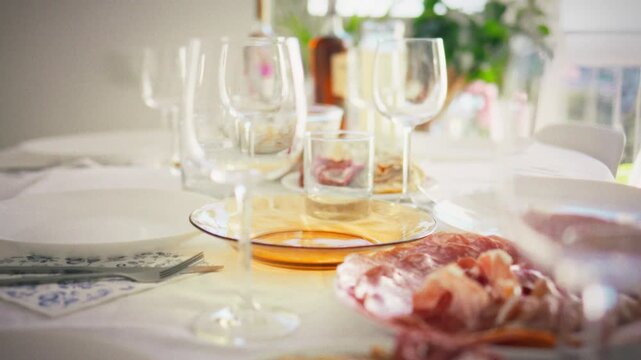 Appetizing homemade food baked meat, jamon slices and fresh salads on white plates, close-up details in sunlight, slow camera flight over a homemade feast for recipe and food delivery ideas