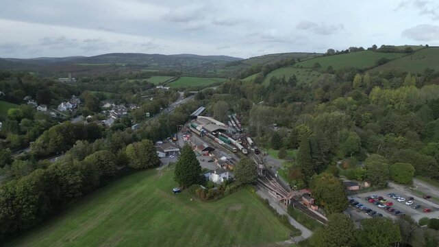Buckfastleigh, Devon, England: DRONE VIEWS: 1. River Dart valley; Buckfastleigh railway station; 2. Traffic on the Devon Expressway (A38); 3. Buckfast Abbey. Devon is a popular UK tourist destination.