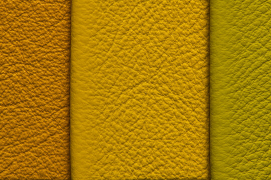 Multi-colored leather texture background with vertical split dividing orange, yellow, and olive green pebble grain sections