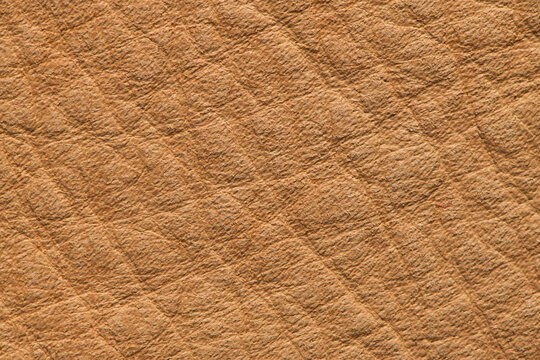 Tan leather texture background with diagonal pebble grain pattern