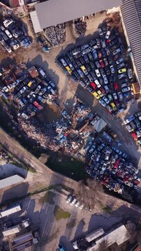 Vehicle scrapyard with tightly packed rows of dismantled cars