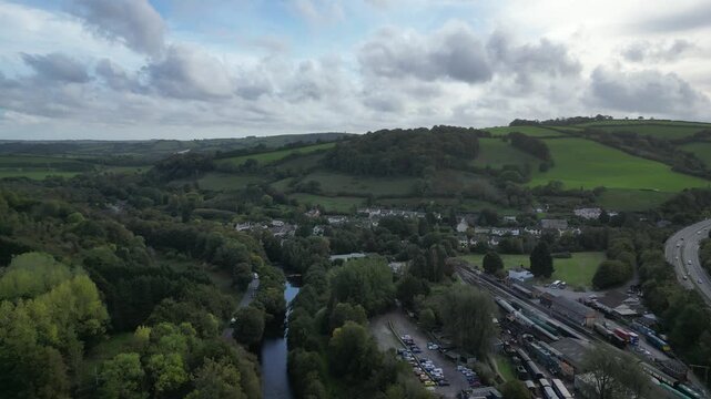 Buckfastleigh, Devon, England: DRONE VIEWS: 1. The River Dart; 2. Traffic on the Devon Expressway road (A38); 3. Buckfastleigh railway station with stationary steam engines & carriages. 