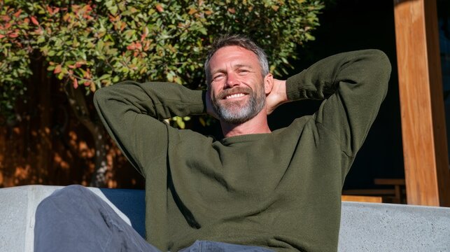 Man Relaxing in Outdoor Setting, Sunglasses, Casual Clothing.