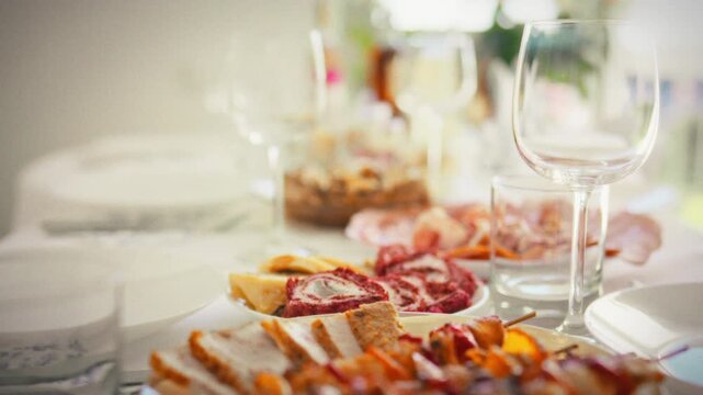 Fresh cooking inspiration meat on wooden skewers, sliced jamon, colorful salads and light appetizers on a sunny table, medium shots with smooth movement, a hearty holiday menu made at home