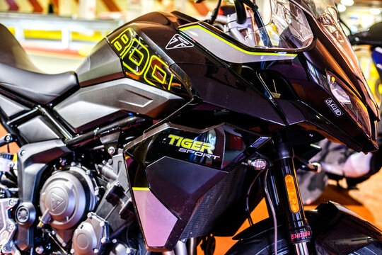 Close-Up Of A Triumph Tiger Sport 800 Motorcycle Showing Black Bodywork Fairings And Yellow Brand Decals