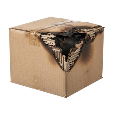 Damaged cardboard shipping box with burnt hole and charring