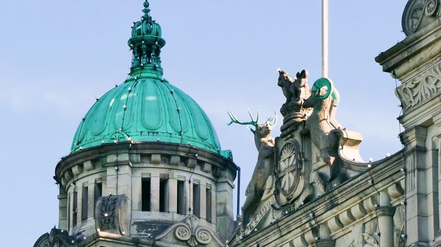 Victoria, British Columbia, Canada - October 15, 2026: Ornate green copper dome and provincial coat of arms on the British Columbia Parliament Buildings
