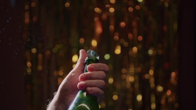 Person opening champagne bottle, birthday. Celebration, achievement at a party. Success, celebrate new year and man bartender with wine, alcohol pub for winning. Slow motion, splashes and foam