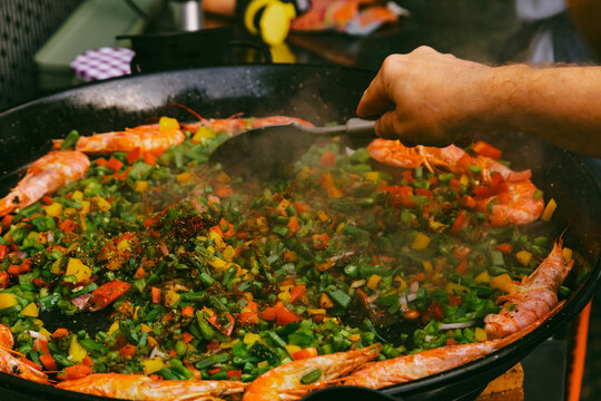 Cooking Shrimp With Vegetables in a Large Pan at Night