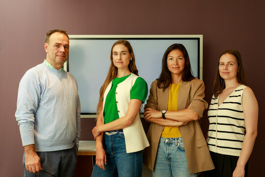 Four People Standing in an Office