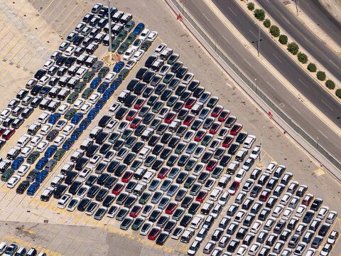 New cars parked at port terminal.