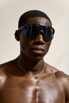 Man wearing sunglasses in a close-up indoor setting