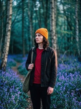 Adult Standing on a Path in a Forest Surrounded by Bluebells