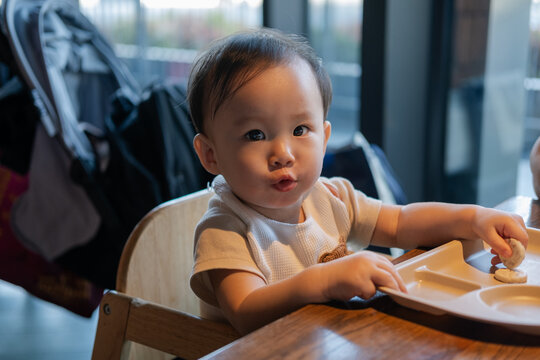 Baby Eating Biscuits in a coffee shop