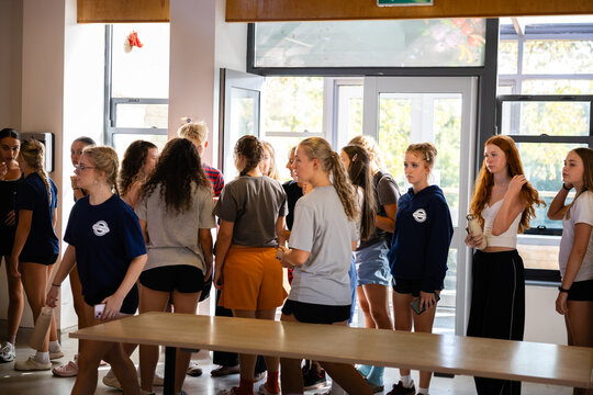 Dance company waits by the canteen doors