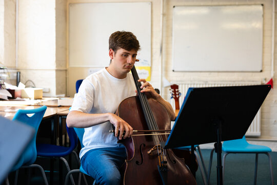 Focused cello practice in classroom