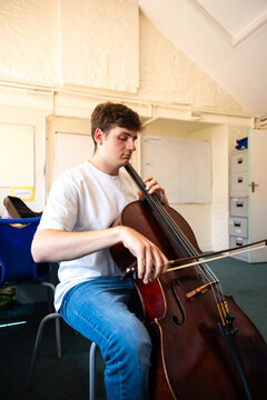 Practicing cello during a rehearsal