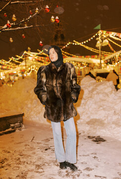 Woman in Fur Coat at Winter Red  With Lights and Snow