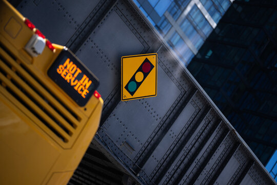 Traffic Signal Warning Sign Above Yellow Vehicle
