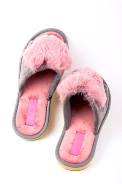 Pink  women's slippers on a white background