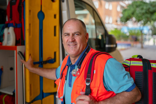 Paramedic standing by ambulance