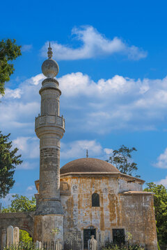 Murat Reis Mosque, Rhodes, Greece. Historic Ottoman mosque built around 1623 near Mandraki Harbor, featuring a domed prayer hall, ornate minaret, and Ottoman cemetery setting.