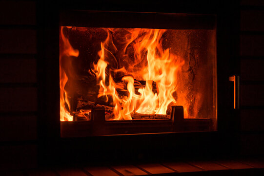 Cozy fire burning inside a modern glass fireplace   