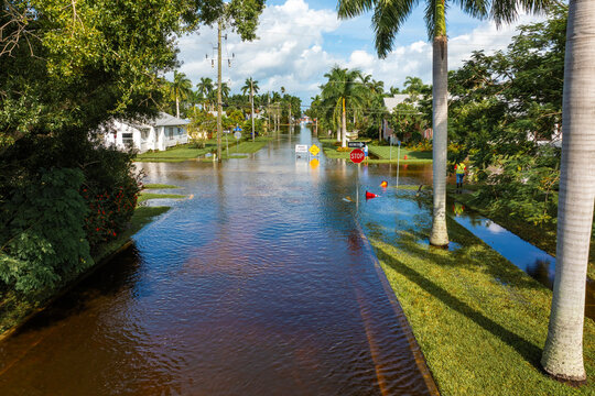 Street under water warning sign. Closed city road because of flooding blocking driving of cars. Consequence of hurricane Milton in Punta Gorda, Florida