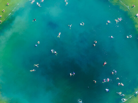 Warm Mineral Springs in North Port, Florida. Outdoor mineral spa lagoon with crystal clear water, visitors enjoying wellness bathing, relaxation and natural therapy.