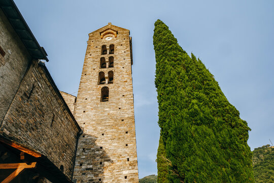 Romanesque Church of Saint-Martin d'Unac with Tall Cypress Tree, Historic Stone Bell Tower, Unac, France