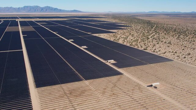 Aerial view of solar panel rows across the Mojave Desert floor