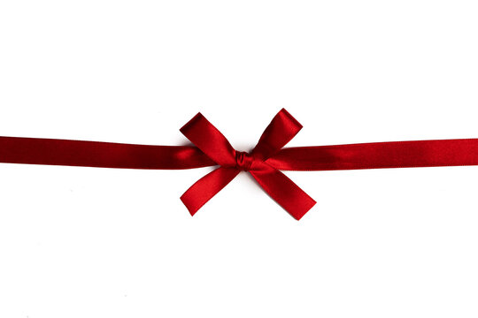 A red ribbon tied in a bow across the page