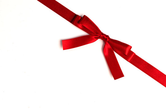 A red ribbon tied in a bow across the page