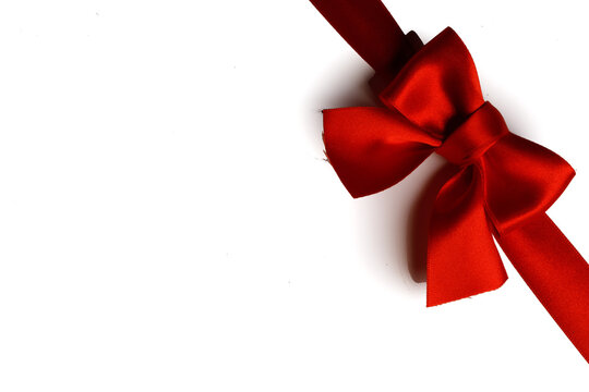 A red ribbon tied in a bow across the page