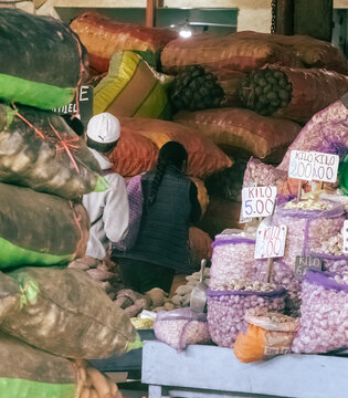 Huancayo, Peru, Per&uacute; : bulk produce section inside Mercado Mayorista. Shoppers move between large sacks of vegetables and agricultural goods.