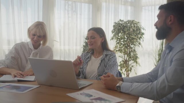 Laptop, collaboration and business people in the office while working on a company project. Technology, teamwork and team doing corporate research in discussion together with technology in workplace
