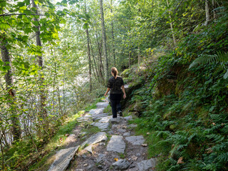 Hiker on Verzasca River trail (Sentiero Verzasca) from Sonogno to Lavertezzo, Switzerland © Catalin