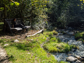 Hiker resting on Verzasca River trail (Sentiero Verzasca) from Sonogno to Lavertezzo, Switzerland © Catalin