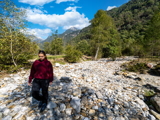 Hiker on Verzasca River trail (Sentiero Verzasca) from Sonogno to Lavertezzo, Switzerland © Catalin