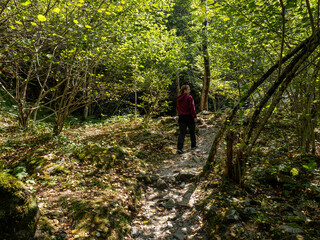 Hiker on Verzasca River trail (Sentiero Verzasca) from Sonogno to Lavertezzo, Switzerland © Catalin
