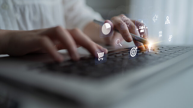 Focused Hands Typing on Laptop Keyboard with Digital Marketing Icons and Graphics Presenting Online Business Concepts and Analytics Haptic.