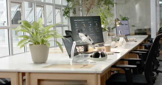 Camera is pulling focus and moving right from blurred start, revealing office desk with monitor